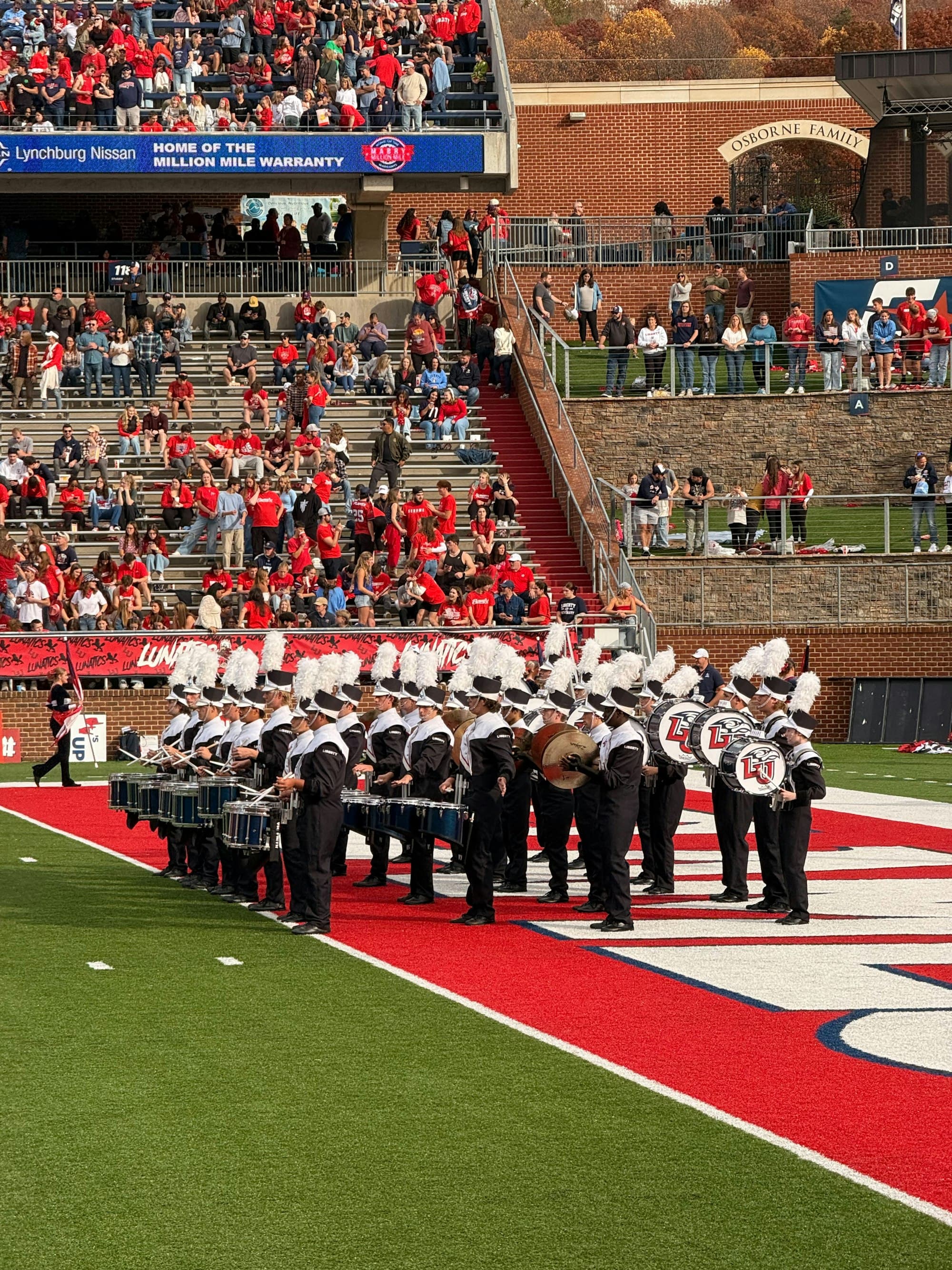 A marching band drumline performing on a football field